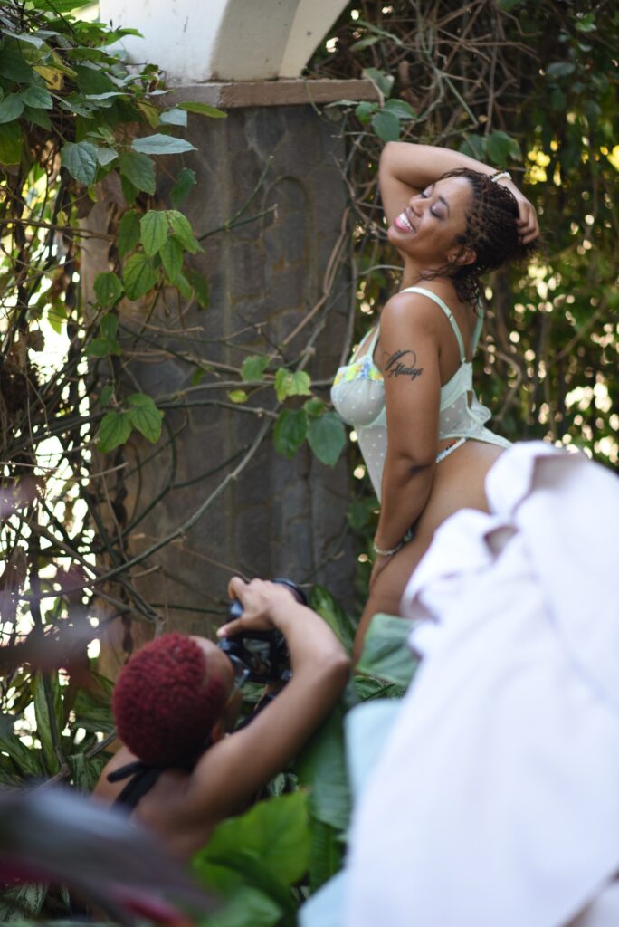 Black woman posing and another capturing her with a camera