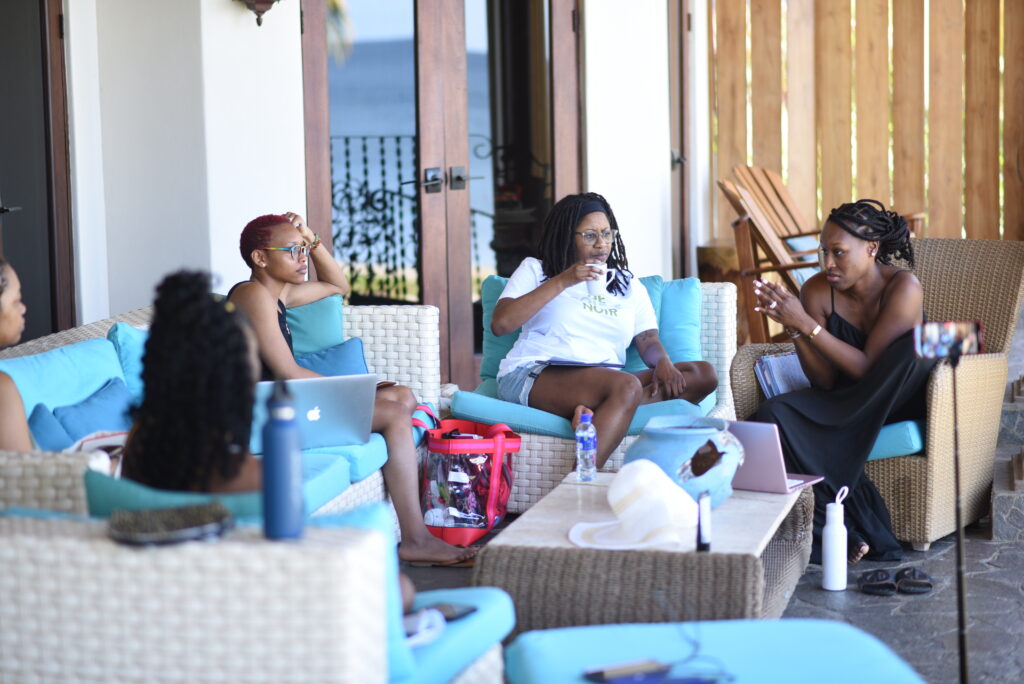 Black women sitting around speaking with each other