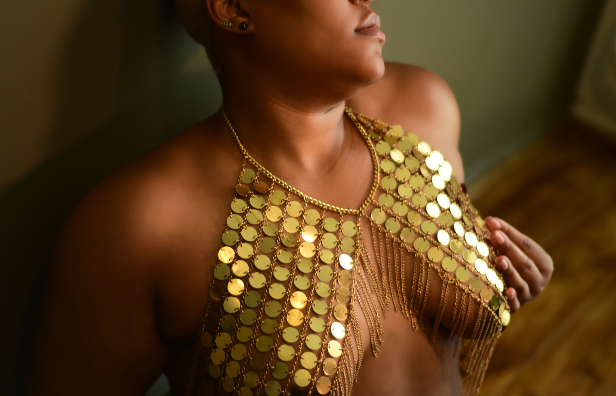 anonymous woman in gold metal bra