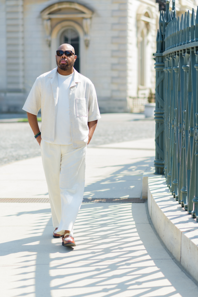 Black man walking in a linen beige set